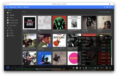A music library interface displaying various album covers and tracks, featuring artists like The Black Keys and Joy Division.