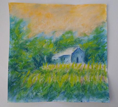 Painting of a house in soft pastel. The house is blue under an orange sky. There are fields and trees around it. The painting is lying on a white table.