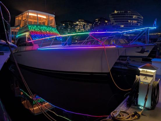 White 46' boat with rainbow led lights on it