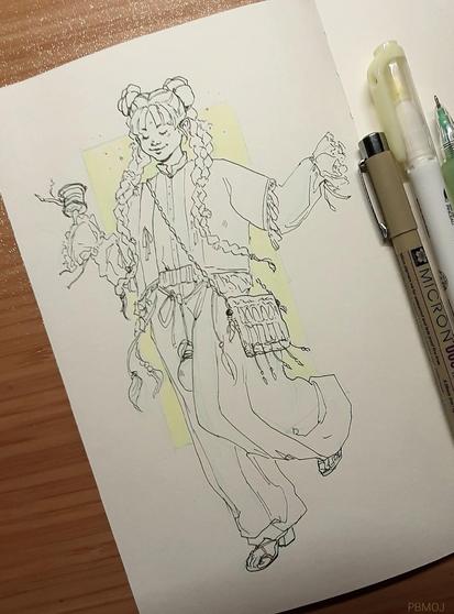 Photo of a sketchbook page: ink drawing (lineart) of a girl in a happy dance like pose