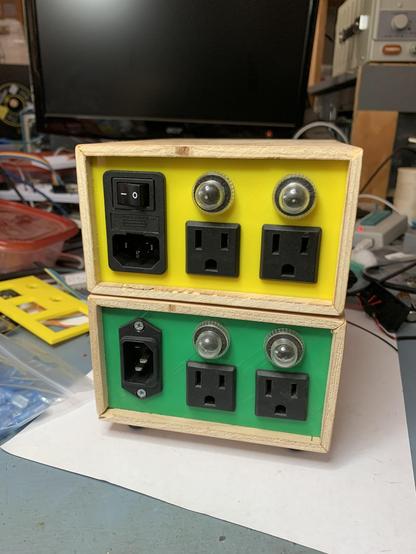 Rear showing the same outlet and power cord configuration, with the only real difference being the upper yellow one has a nicer cord socket with integrated switch & fuse.
