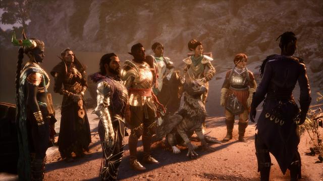 A diverse group of eight characters stands in a warm, dimly lit environment, with rocky terrain in the background. They are dressed in elaborate, armor-like attire, and one character has a griffon companion at their side.