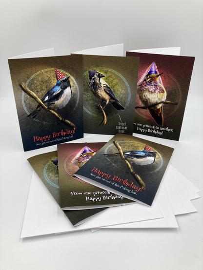 Product photograph of six birthday cards featuring three different illustrations of birds in hats