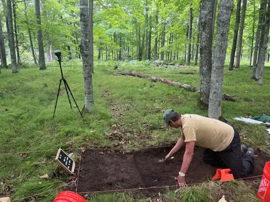 Jonathan Alperstein, one of the researchers, excavates a portion of land on an ancient agricultural site in Michigan.