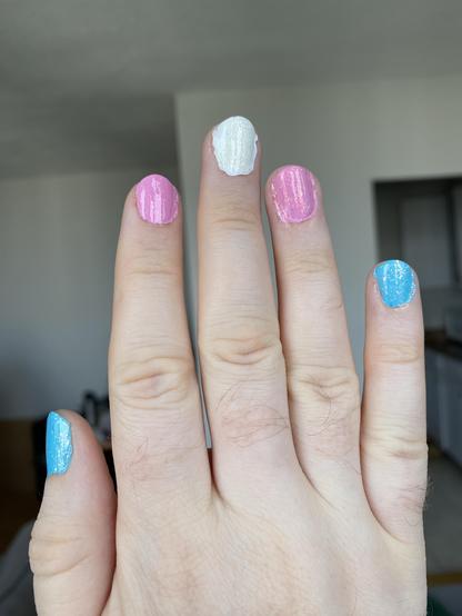 My right hand with each nail a colour in the trans flag.

The thumb and pinky are blue, index and ring pink, and the middle in white.