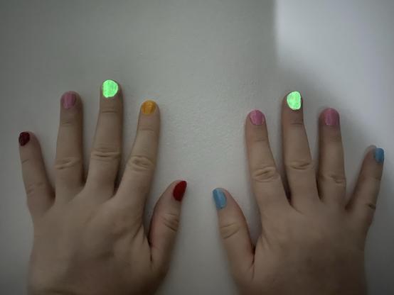 Both of my hands against a white door, to keep them from shaking as I took a night shot photo with my camera.

It's a bit hard to realize it's dark in the area, but both of my middle fingertips are glowing green with glow in the dark polish.