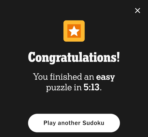Screen capture of a digital congratulations message with black background, white text, and an orange square containing a white star. The message reads "Congratulations! You finished an easy puzzle in 5:13." A white button at the bottom states "Play another Sudoku." At the top right corner of the screen is a white close symbol.