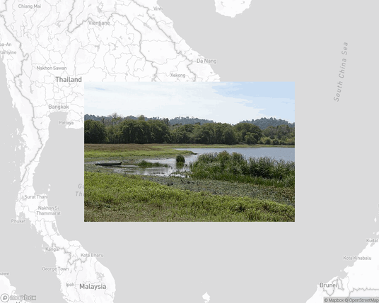 A photo of or from a national park from the linked website, overlaid on a cropped world map where it's located.