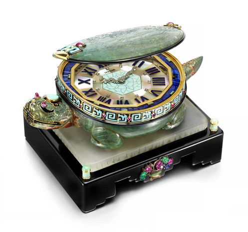official auction photo, diagonal turn side profile on white background - shell lid open “It features a clock face, edged in gold with diamond-set hands in the form of a dragon, hidden inside a turtle's shell decorated with black and turquoise enamel and ruby cabochons, as well as carved rubies, emeralds and sapphires on the base.”