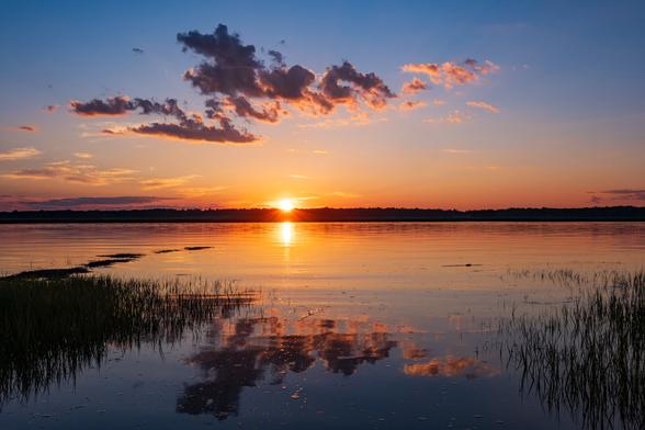 The sun sets over the marsh across Black Rock Creek.Flat water reflects the sunset and clouds.
© Tom Goetz. All rights reserved. Training an AI on this image is expressly forbidden.