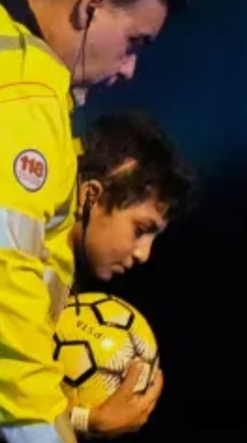 Screenshot from part of the photo in https://www.aljazeera.com/news/2025/6/12/boy-who-lost-nine-siblings-in-israeli-attack-arrives-in-italy-for-treatment (part of the text also originated from that article).

Behind an Italian aid worker a boy holding a football can be seen. A scar on his head can be seen.