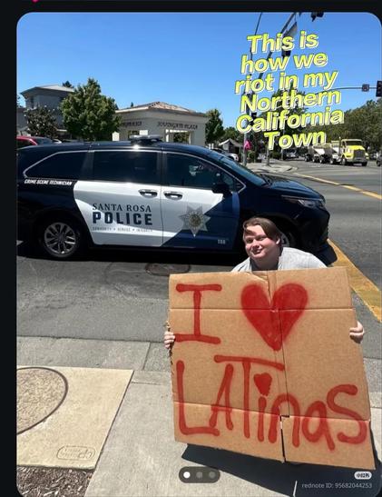 This is how we riot in my Northern California Town:

[A man crouching in front of a cop car holding a cardboard sign that says, "I ❤️ Latinas"]