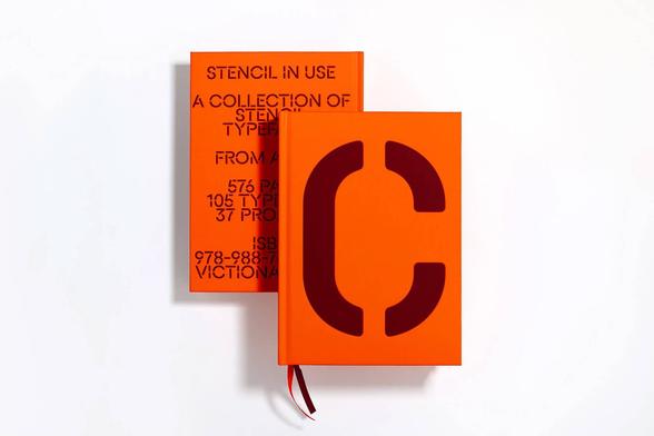 Two vibrant orange books stacked, featuring bold black text and a large letter "C" on the cover, showcasing stencil typography.