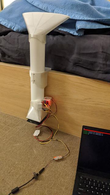 A pipe-based contraption mounted to the base of a bed