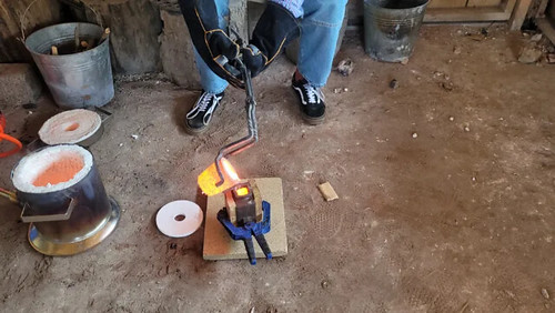 Photograph from the article of a student pouring the molten metal