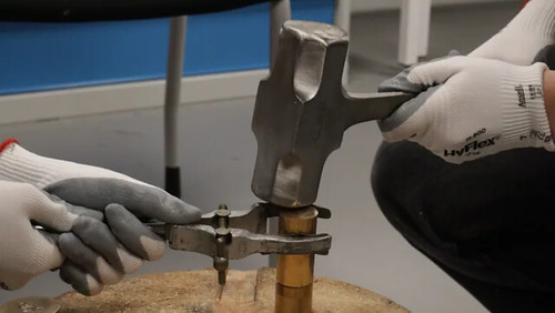 Striking the dies with the coin between - modern safety (gloves, tongs, etc) meets ancient coin striking techniques!