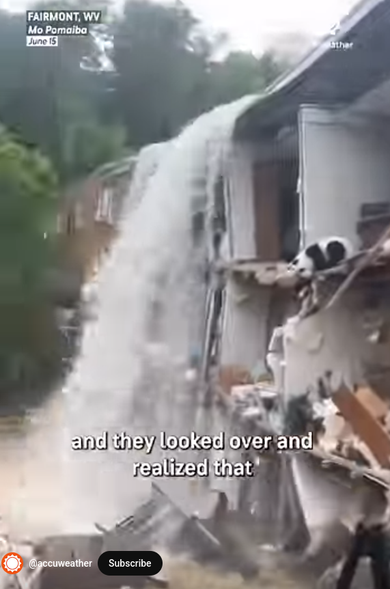 Flash flood going OVER THE TOP OF A BUILDING