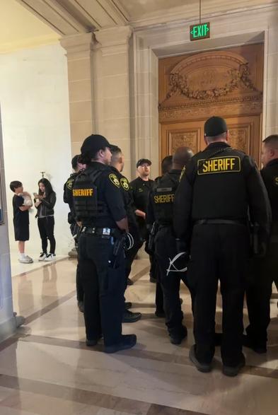 Sheriff deputies outside the main chamber.