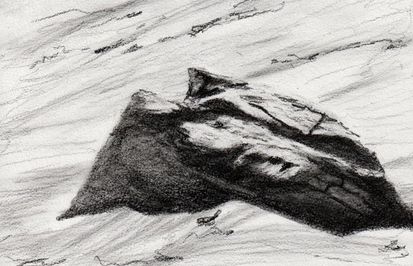 Graphite sketch of a boulder emerging from the sand.