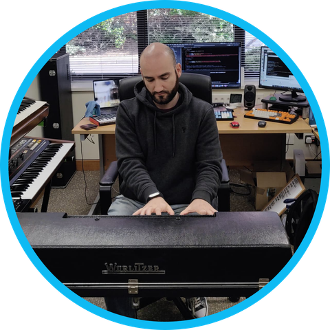 Carlo Castellano in the AudioThing office playing an instrument.