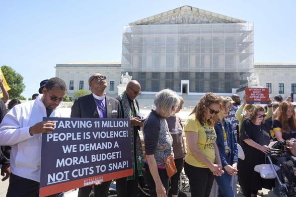 Activists with the Poor People's Campaign protest against spending reductions across Medicaid, food...