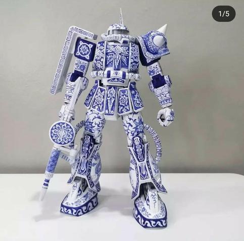 A Zaku Gunpla kit painted to look like white porcelain with blue patterns in a traditional style.
