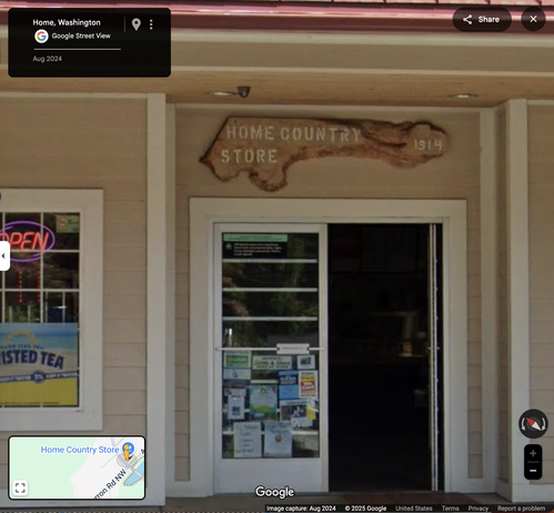 Google streeview shot of the Home Country Store, founded 1914, when the unincorporated town was a thriving anarchist/discontent/nudist/free love/etc colony. It's a piece of lumber cut from a large tree that, due to the various splits of trunk, came out in the shape of a large penis and two-balls-visible ballsac.