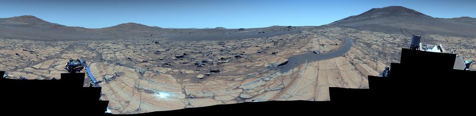 A color-enhanced mosaic capturing a Martian landscape.