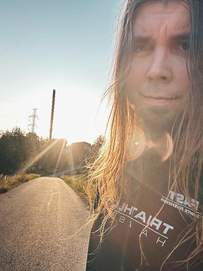 Another selfie from the run, sun shining, smiling long haired man