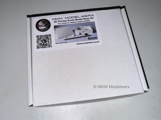 A white box with a label featuring the page’s logo and a description of what will be in the box.