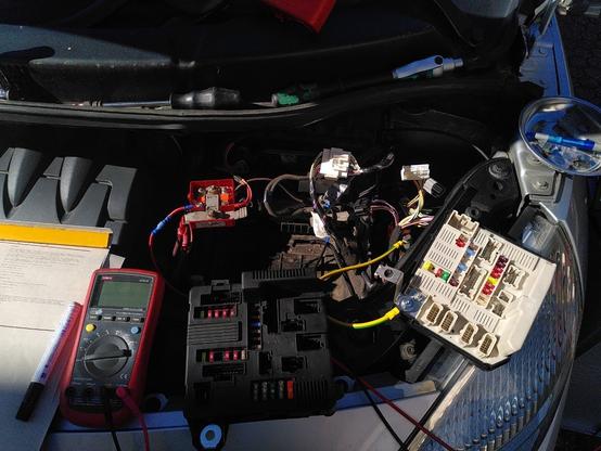 Electronic control units, wires, tools, test equipment and some paper with notes