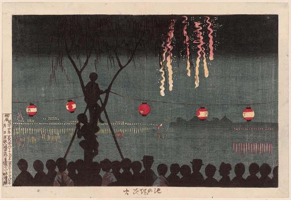 A crowd watches fireworks dropping from a dark sky over water. Two people have climbed a tree for a better view.