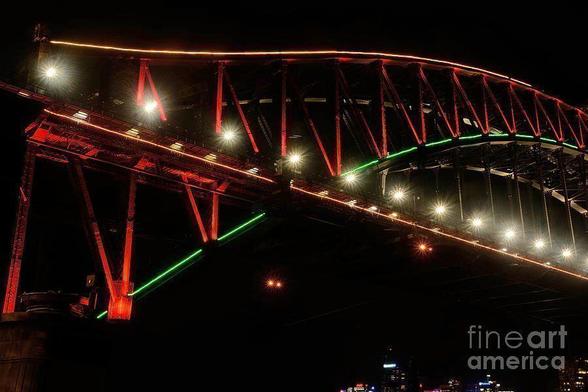 A close up view of the beautiful Sydney Harbour Bridge during Vivid Sydney festival 2016.
The lights cast on the bridge were changing color every few seconds. I liked the brightness of the red and green on the steel structure with the lights bursting like stars.
I captured this image June 2016 at the Vivid Sydney festival.
By Kaye Menner Photography
https://kaye-menner.pixels.com/featured/harbor-bridge-green-and-red-by-kaye-menner-kaye-menner.html

THE FINE ART AMERICA LOGO WILL NOT SHOW ON PURCHASED PRINTS OR PRODUCTS.

[From Vivid Sydney site - http://www.vividsydney.com/ ]
"Vivid Sydney is a festival of light, music and ideas.

Vivid Light transforms Sydney into a wonderland of 'light art' sculptures, innovative light installations and grand-scale projections for all to enjoy - for free. It is a magical celebration of light-design excellence and the world's largest outdoor 'art-gallery': a unique Vivid Sydney experience.

Vivid Light engages lighting artists, designers and manufacturers from around Australia and the world to illuminate, interpret and transform Sydney's urban spaces through their creative vision."