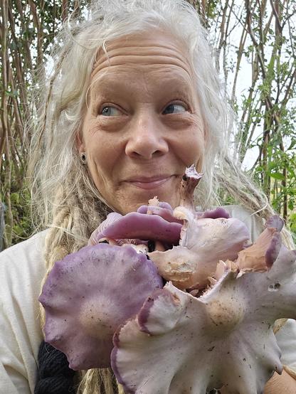 Me. Cheesing over a handful of wild purple mushrooms.