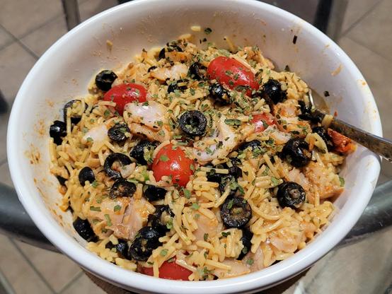 A Mediterranean bowl; rockfish, black olives, grape tomatoes, rice, and parsley.
