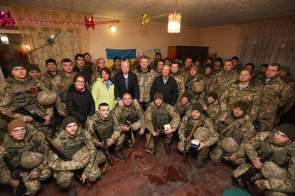 Amy Klobucher  with John McCain and Lindsey Graham surround by Ukraine Nazis in 2019. Ted Cruz was on the trip too, but did not pose on a bloodstained rug with a bunch of killers.