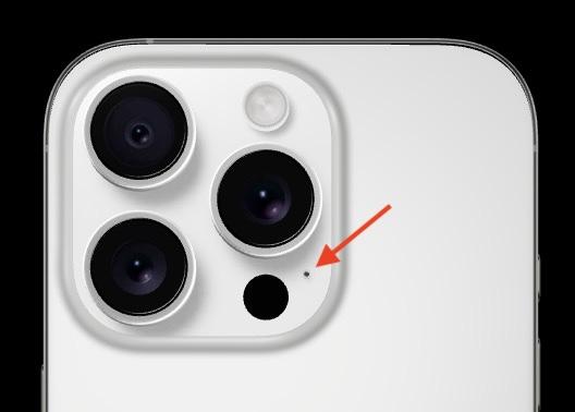 A closeup of an iPhone 16 Pro camera, with a red arrow pointing to the ambient noise mic.