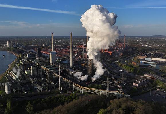 An aerial view of a coking tower belching a cloud of steam at the Thyssenkrupp steel mill on 8 April 2025 in Duisburg, Germany. | Photo by Sean Gallup/Getty Images