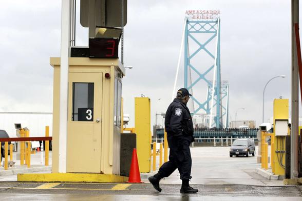 Vehicles enter the United States from Canada across the Ambassador Bridge at a U.S. Customs port of entry in December 13, 2004, in Detroit, Michigan.