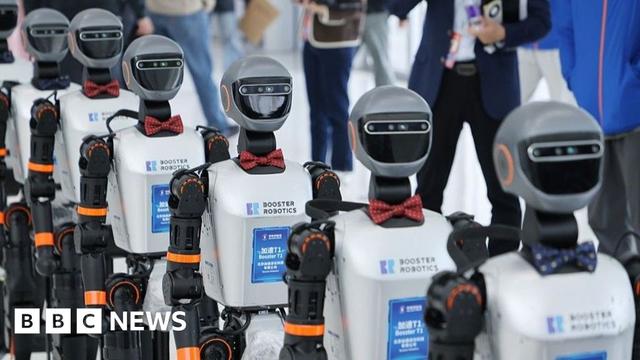 Six robots from Booster T1 walking in a line.