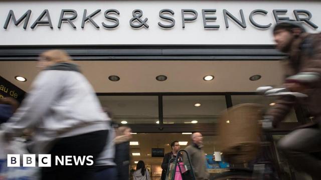 People walking past a Marks & Spencer store