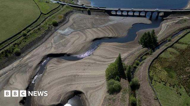 An aerial photo shows the bed of Woodhead Reservoir is partially revealed by a falling water level, near Glossop, northern England on May 9, 2025.