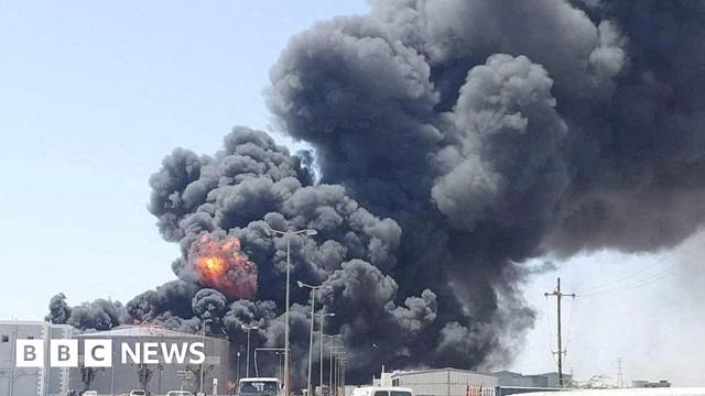 Smoke and fire billows over a fuel depot in Port Sudan.