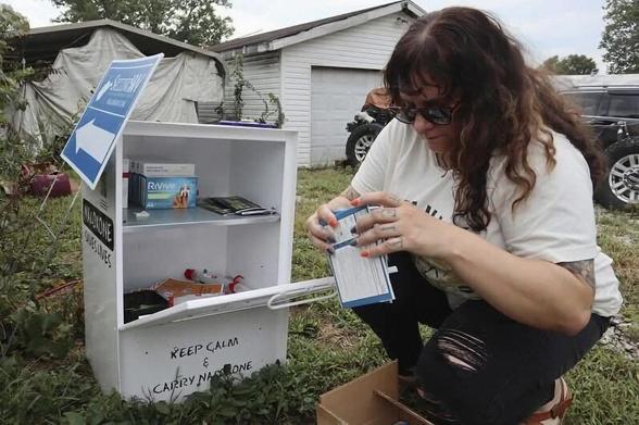 Tasha Withrow, a volunteer with Project Mayday a harm reduction collective in Charleston, West Virginia, refills a community free box with the lifesaving overdose reversal drug naloxone. West Virginia has the nation's highest overdose fatality rate
