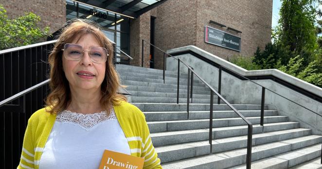 Maria Caltabiano holds a copy of her first book, Drawing Daybreak, a collection of poems she wrote remembering her late husband who died of cancer. (Swidda Rassy/CTV News)
