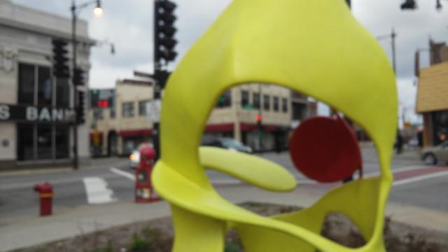 Yellow swirly with a dot of red abstract Objet de Arte in Jefferson Park in 2017