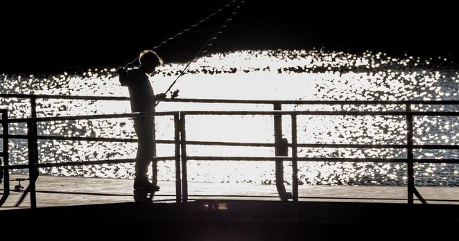 BIG BEAR LAKE, CA: MAY 23, 2025: A youngster's fishing line glistens against Big Bear Lake in the late afternoon at Boulder Bay Park on May 23, 2025 in Big Bear Lake, California.(Gina Ferazzi / Los Angeles Times)