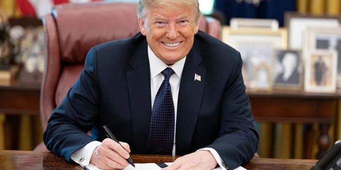 Il presidente USA Trump mentre firma un ordine esecutivo