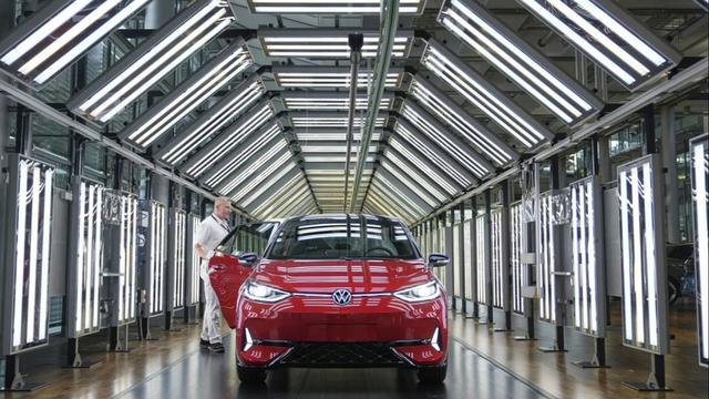An employee of the German car manufacturer Volkswagen checks an ID.3 electric car at the transparent factory in Dresden, Germany, Wednesday, 14 May 2025. | Copyright Matthias Schrader/Copyright 2025 The AP. All rights reserved