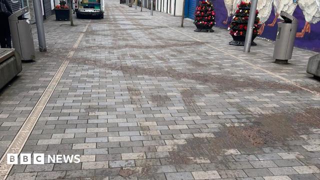 Slurry spread in a zig-zag pattern down a pedestrian street.